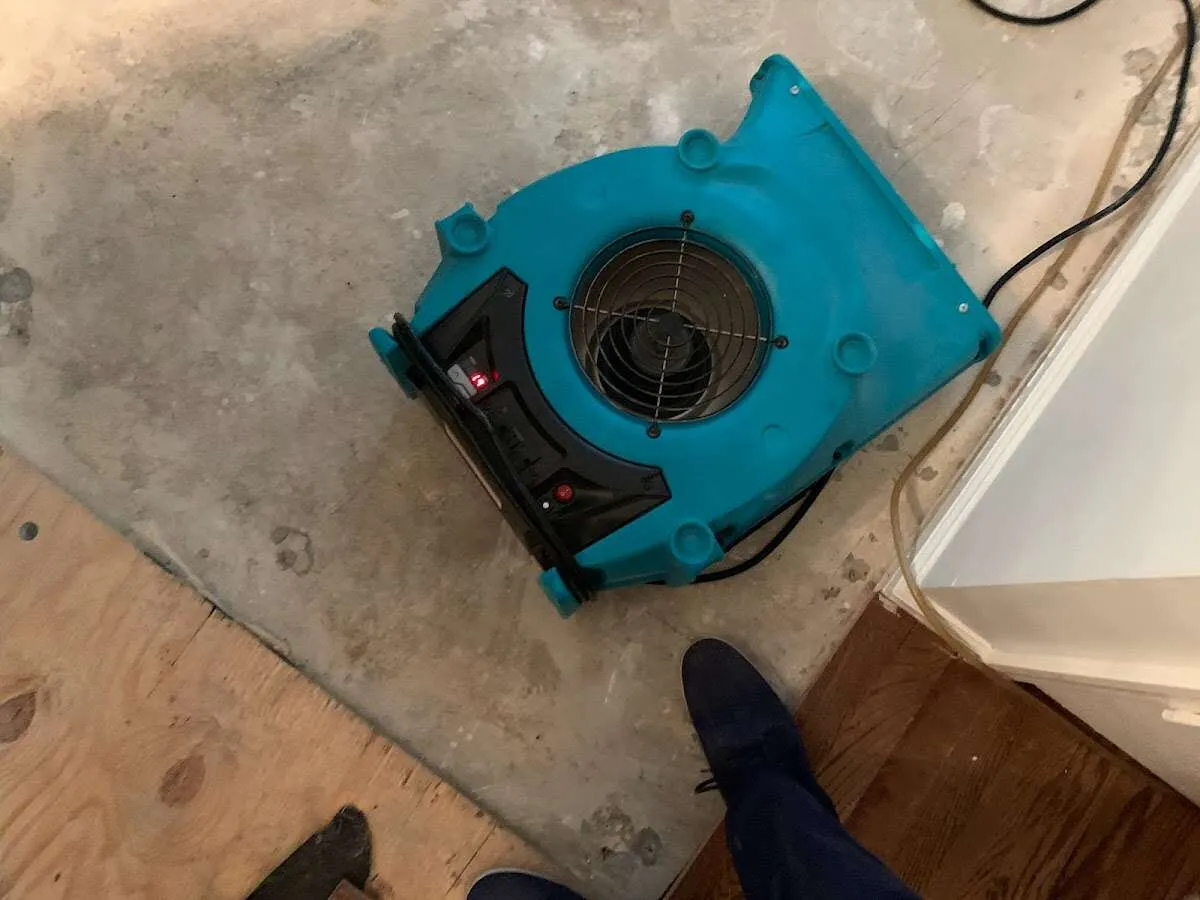 Air mover drying subfloor during Leak Detection & Repair in Kearns